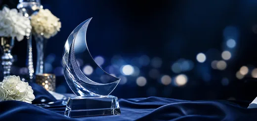 Silver award trophy on a blue formal-event table
